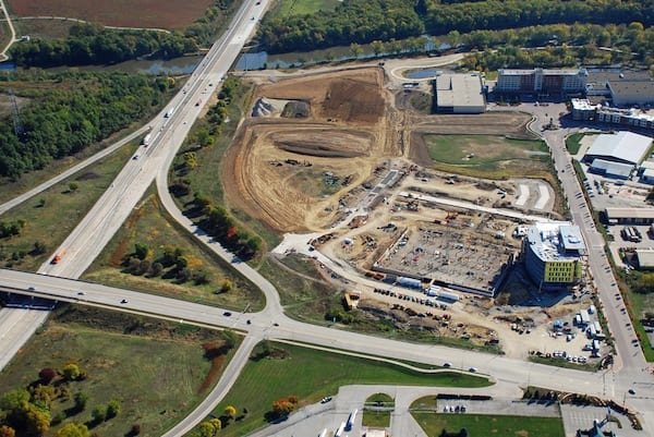Looking E at the Iowa River Landing. New UIHC Clinic, parking ramp, and streets under construction. Coralville Marriott upper right.