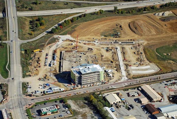 Looking N at the Iowa River Landing. New UIHC Clinic, parking ramp, and streets under construction. E. 9th Street in foreground. 1st Avenue left. Interstate 80 across top.